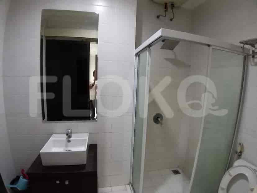 A bathroom with a sink, mirror, and shower.