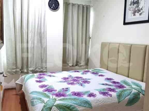 A cozy bedroom with a double bed and floral bedspread.