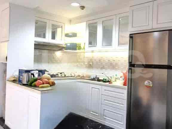 A modern kitchen with white cabinets and stainless steel appliances.