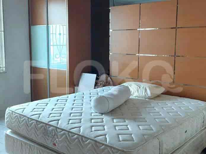 Bedroom featuring a double bed, wooden wardrobe, and neutral decor.