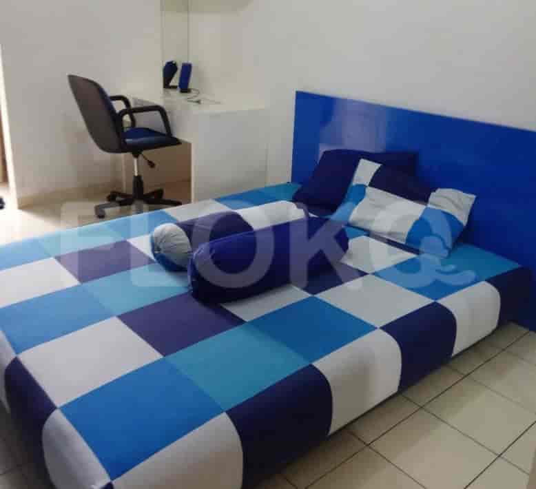 A blue-themed bedroom with a bed, desk, and chair.