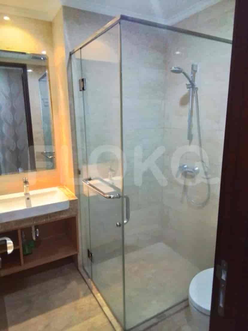 A modern bathroom with a glass shower and a white vanity.