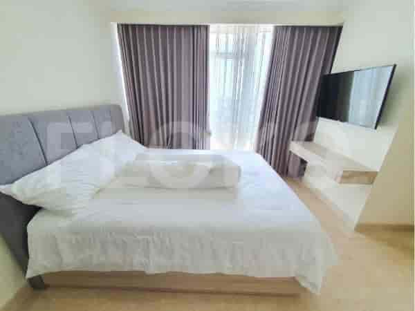 A comfortable bedroom with a large bed and city view.