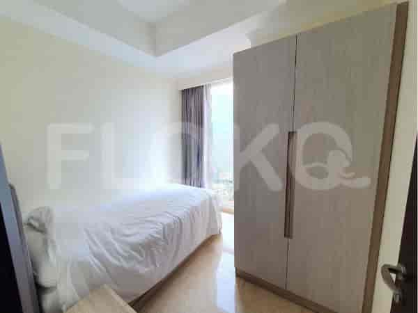 A second bedroom featuring a single bed and a large wardrobe.