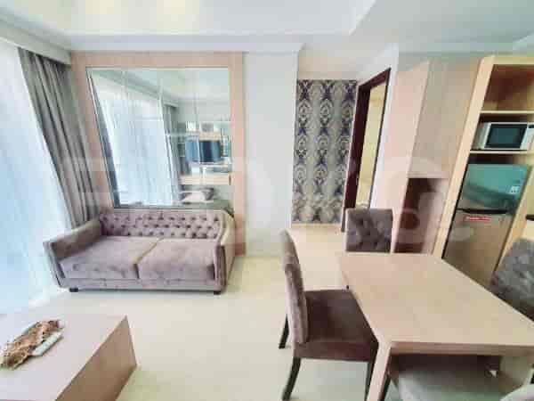 A modern living room with a sofa, dining table, and TV area.