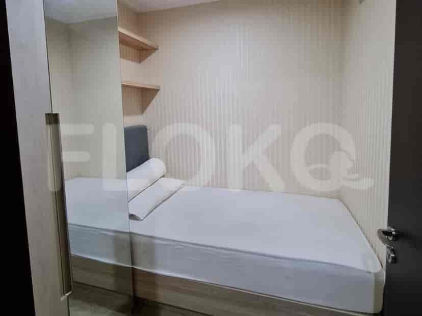 Small bedroom with a single bed and simple decor.
