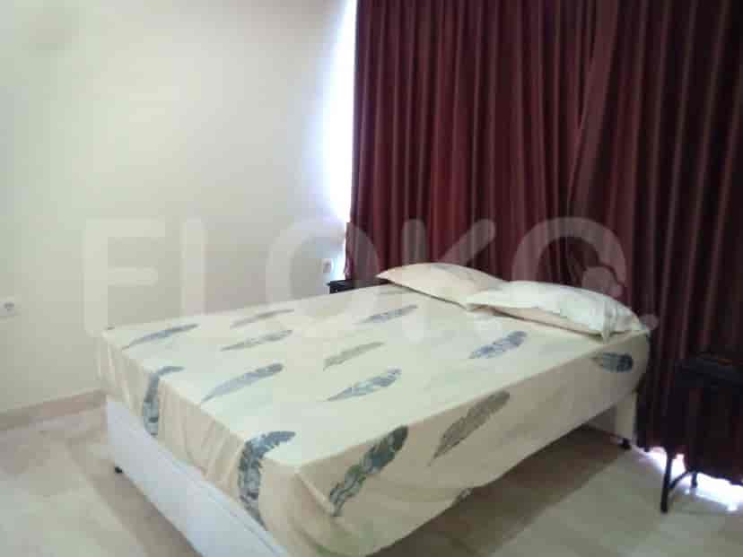A bedroom featuring a bed and curtains.