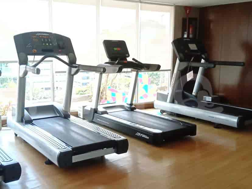 A gym with treadmills and other exercise equipment.