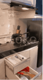 Modern kitchen with appliances, cabinets and shelves.