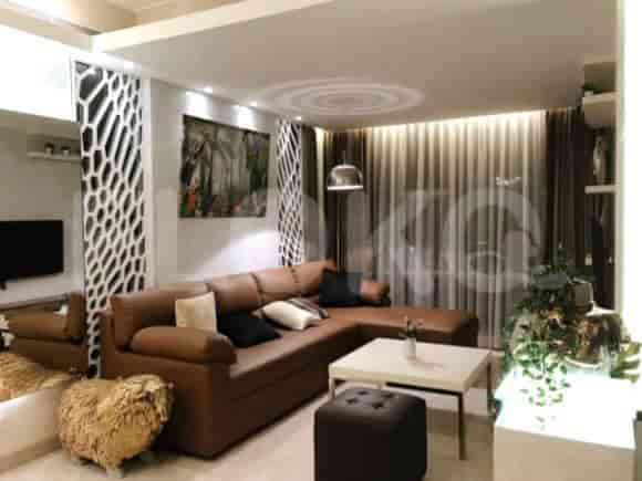 A modern living room with a brown leather L-shaped sofa, decorative panels, and a large painting.
