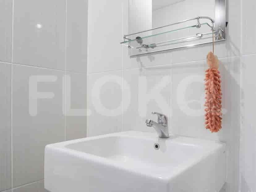 A modern bathroom with a sink, faucet, and a mirror.