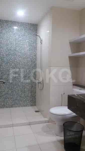 A modern bathroom with a shower, toilet, and a vanity.
