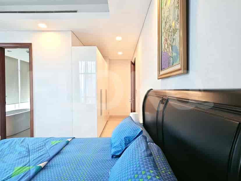 A modern bedroom with a double bed and a wardrobe.
