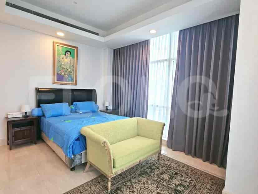 A modern bedroom with a double bed and a sofa.