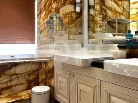 A luxurious bathroom with marble walls and modern fixtures.