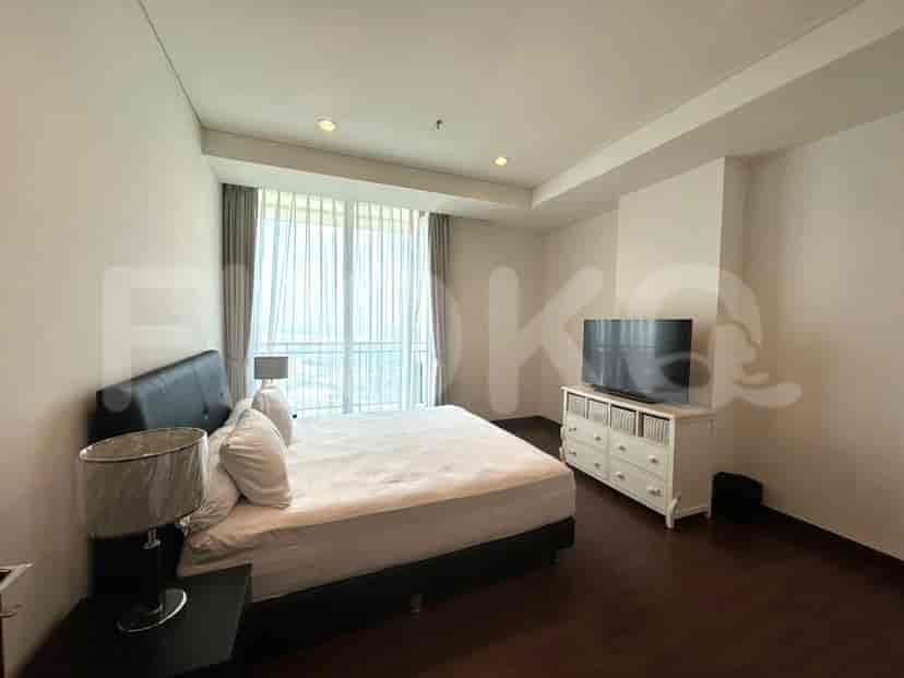 Bedroom with a bed, nightstands, and a TV.