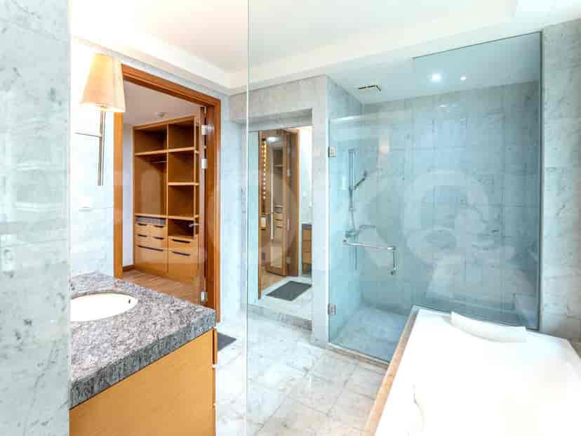 Luxurious bathroom with a shower and marble detailing.