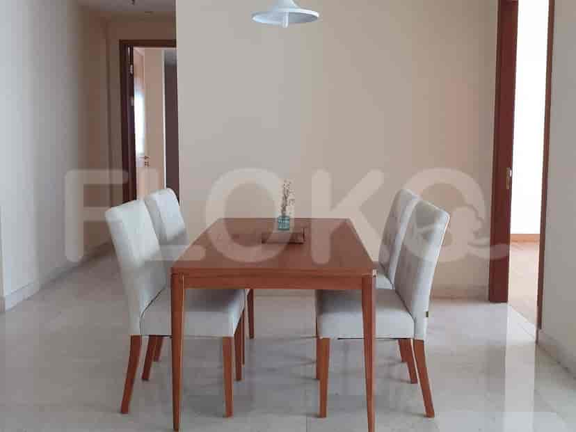 Another view of the dining area with wooden table and four chairs.