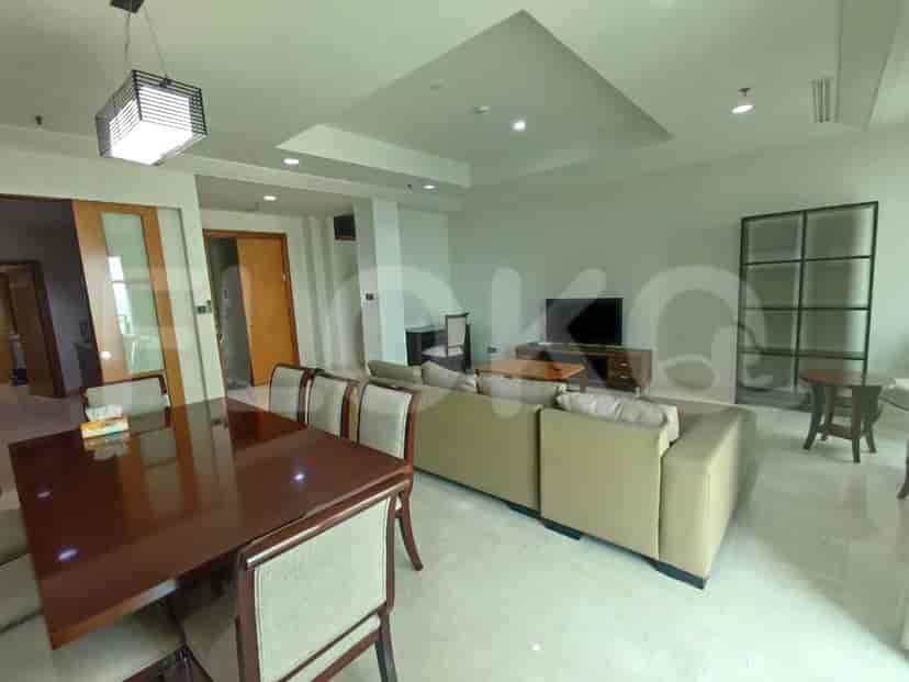 Open-plan living and dining room with a table, chairs, and sofa.
