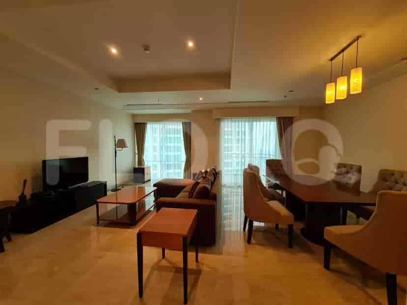 Spacious living room with a brown sofa, TV, and dining area.