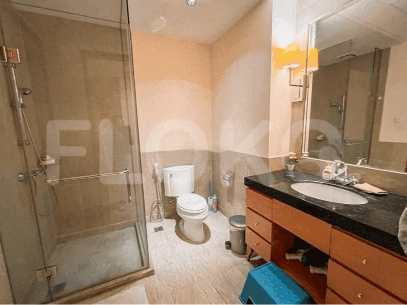 A bathroom with a toilet, sink, and shower.