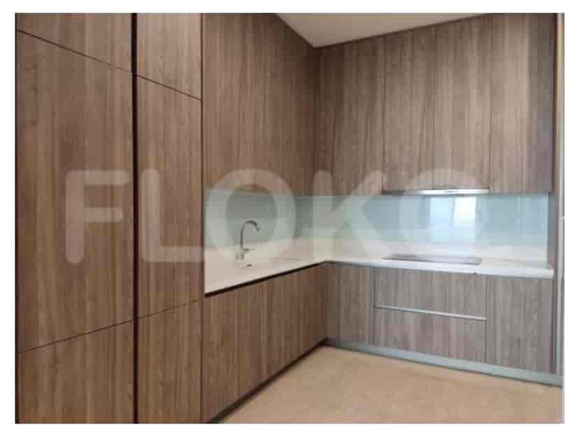 A modern kitchen with wood cabinets, a white countertop, and a glass backsplash.