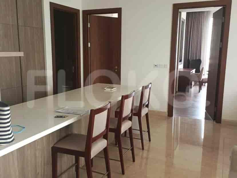 A breakfast bar with seating, connecting the kitchen to another room.
