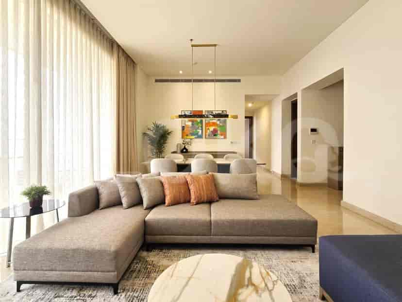 Ruang tamu modern dengan sofa berbentuk L, area makan, dan jendela besar.