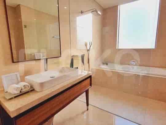 A modern bathroom with a bathtub, shower, and double vanity.