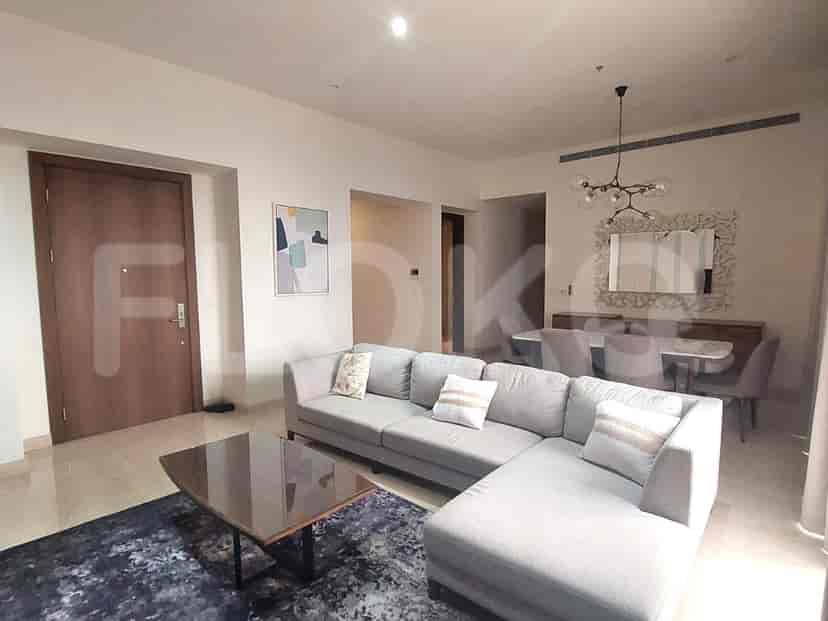 Spacious living room with a grey sectional sofa, a dining area, and a modern style.