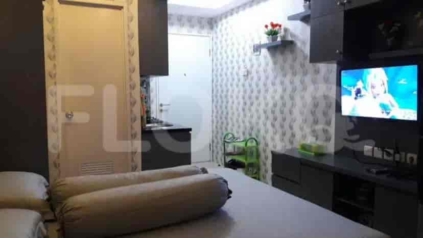 A small apartment showing a combination of living, sleeping, and kitchen areas.