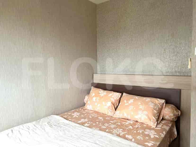 Bedroom with a double bed, patterned bedspread, and neutral wallpaper.