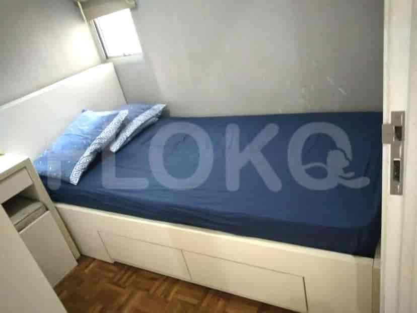 A small bedroom with a bed, likely a single bed.