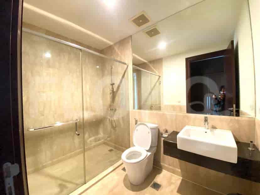 A modern bathroom with a walk-in shower and a large mirror.