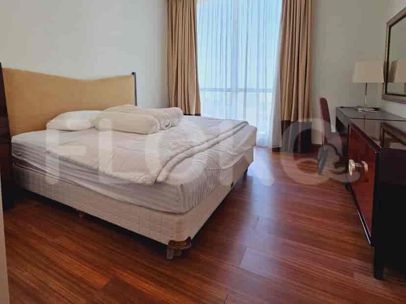 A bedroom featuring a bed and a wooden desk.