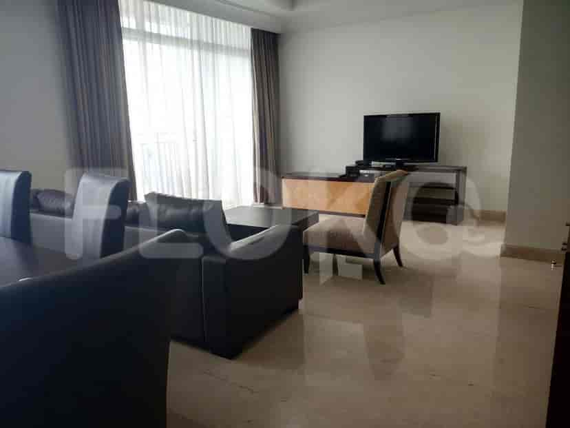 A living room featuring a smart TV, sofa, and a chair.