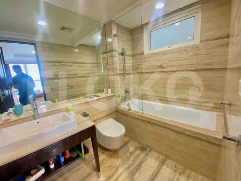 A luxurious bathroom featuring a bathtub, a large mirror, and marble finishes.