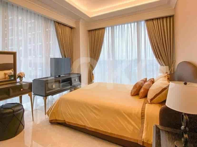Bedroom with a bed, curtains, and a TV.