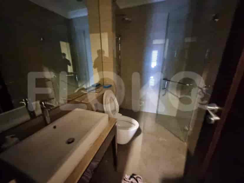 A modern bathroom with a glass shower and toilet.