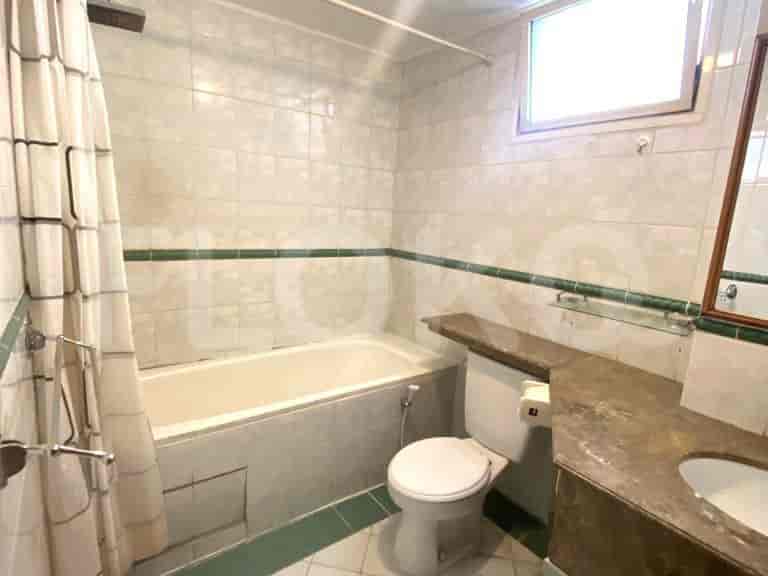 Functional bathroom with a bathtub and a mirror.