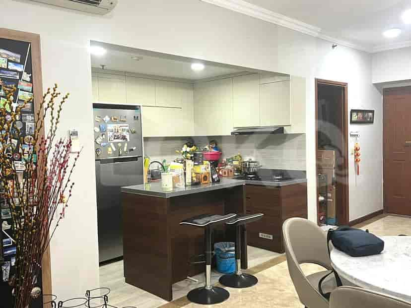 An open kitchen with a breakfast bar, connected to a dining area.