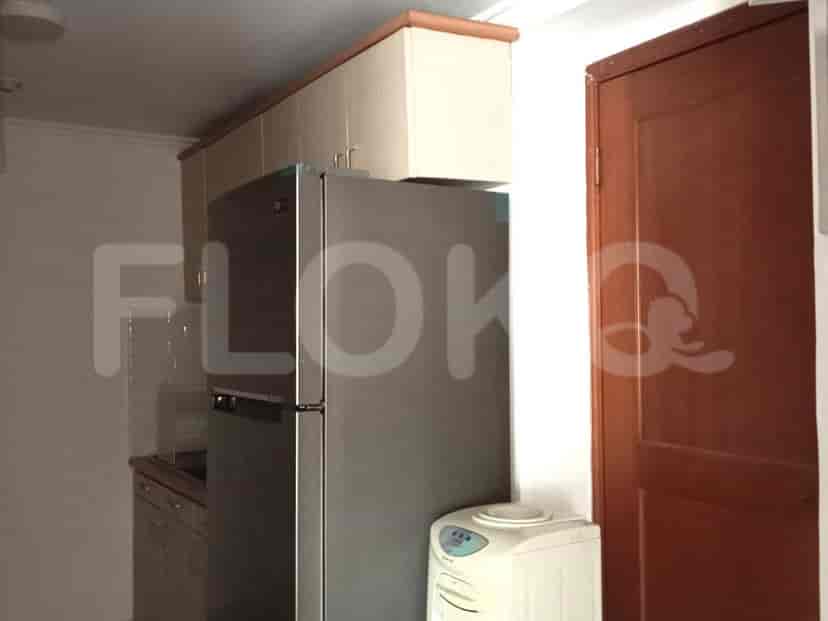 Kitchen featuring refrigerator, cabinets, and a water dispenser.