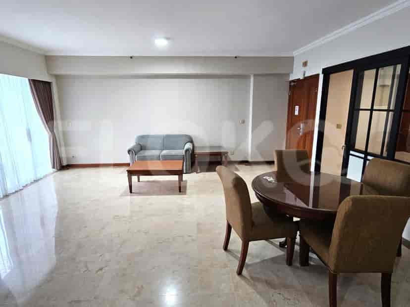 Spacious living room with a sofa, coffee table, dining table, and marble flooring.