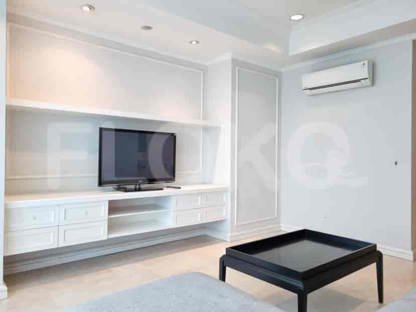 Living room with a TV and storage unit.