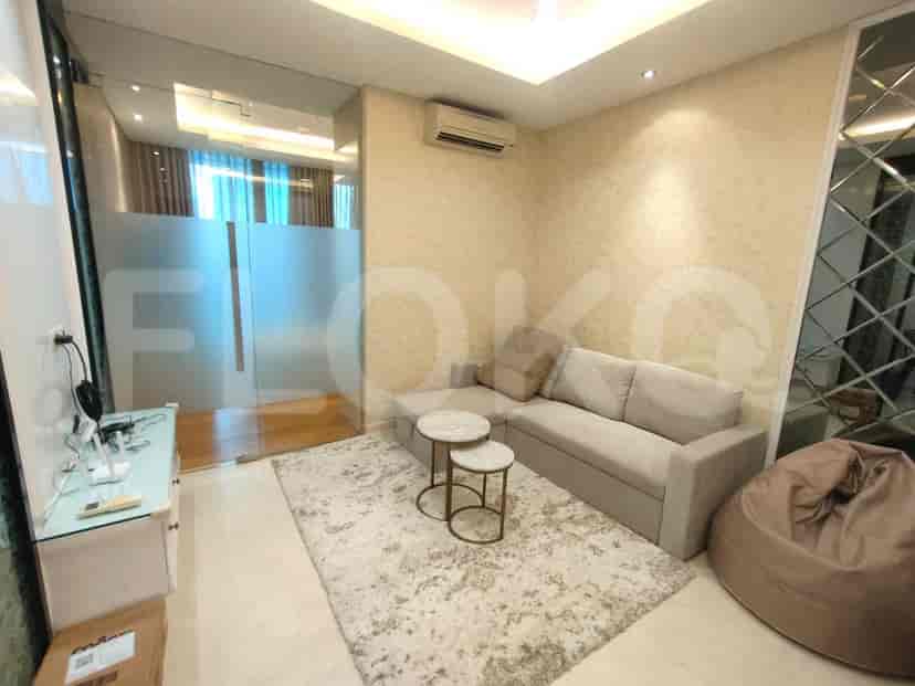 A modern living room with an L-shaped sofa, coffee tables, and a beanbag.