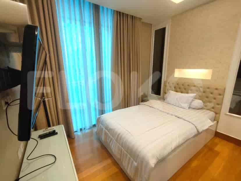 Another bedroom with a bed, curtains, and a window.