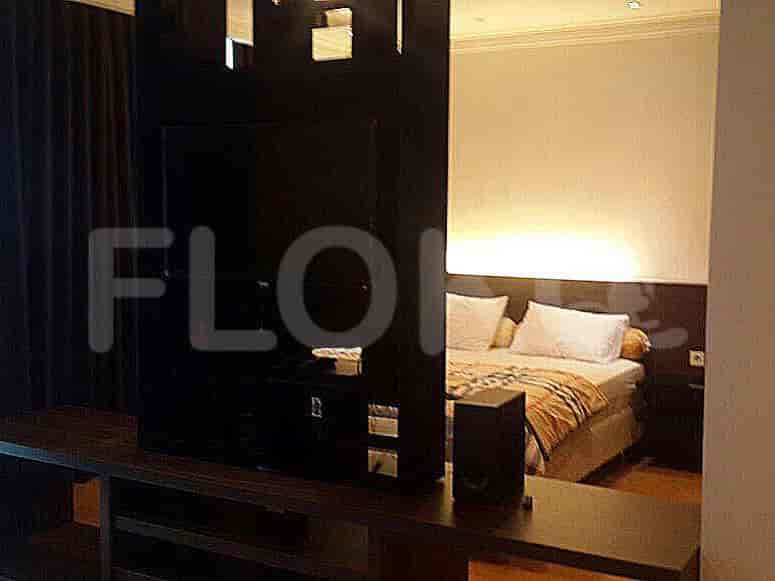Bedroom with partition to separate bed and TV.