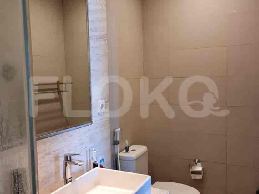 Bathroom with a toilet and mirror.