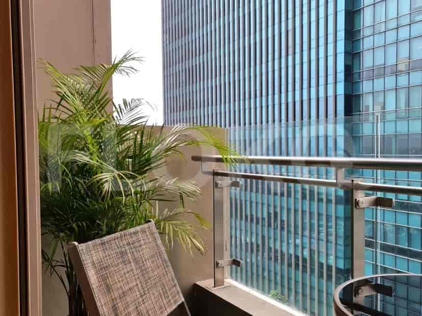 Balcony with a plant and a view.