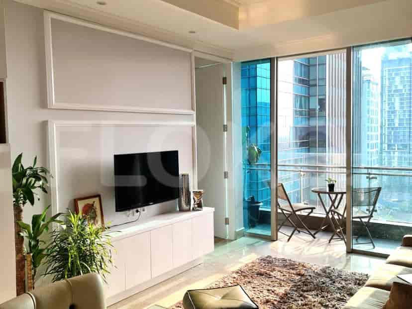 Living room with a balcony overlooking city view.